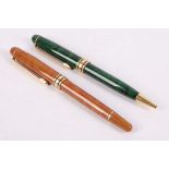 A Mont Blanc gilt and lacquer finish ballpoint pen and a propelling pencil (2).