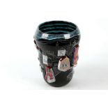 A 1950s SAN POLO STONEWARE VASE, decorated with town buildings in deep relief, on black ground,