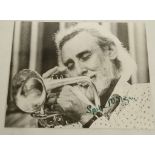 MILLIGAN, Spike (1918-2002). A SIGNED monochrome 10 x 8''  photograph of Milligan playing a trumpet.