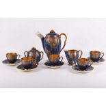 A 1930s Carlton Ware lustre coffee set, consisting of a coffee pot, five cups and saucers, milk