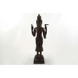 A large 19th Century Sino-Tibetan cast bronze statue of a four armed deity, raised on a square