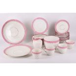 An English porcelain part tea service, 19th Century, spirally fluted with pink and gilt-line rims,