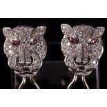 A pair of 'cougar head' earrings, diamond encrusted with ruby eyes.j