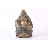 A bronze seated Buddhist figure, with right hand rested on the knee.