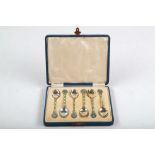 A cased set of Art Deco, hallmarked silver teaspoons, having green and blue enamel flowery