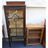 An Edwardian mahogany pier display cabinet with gallery top and three shelves, raised on square