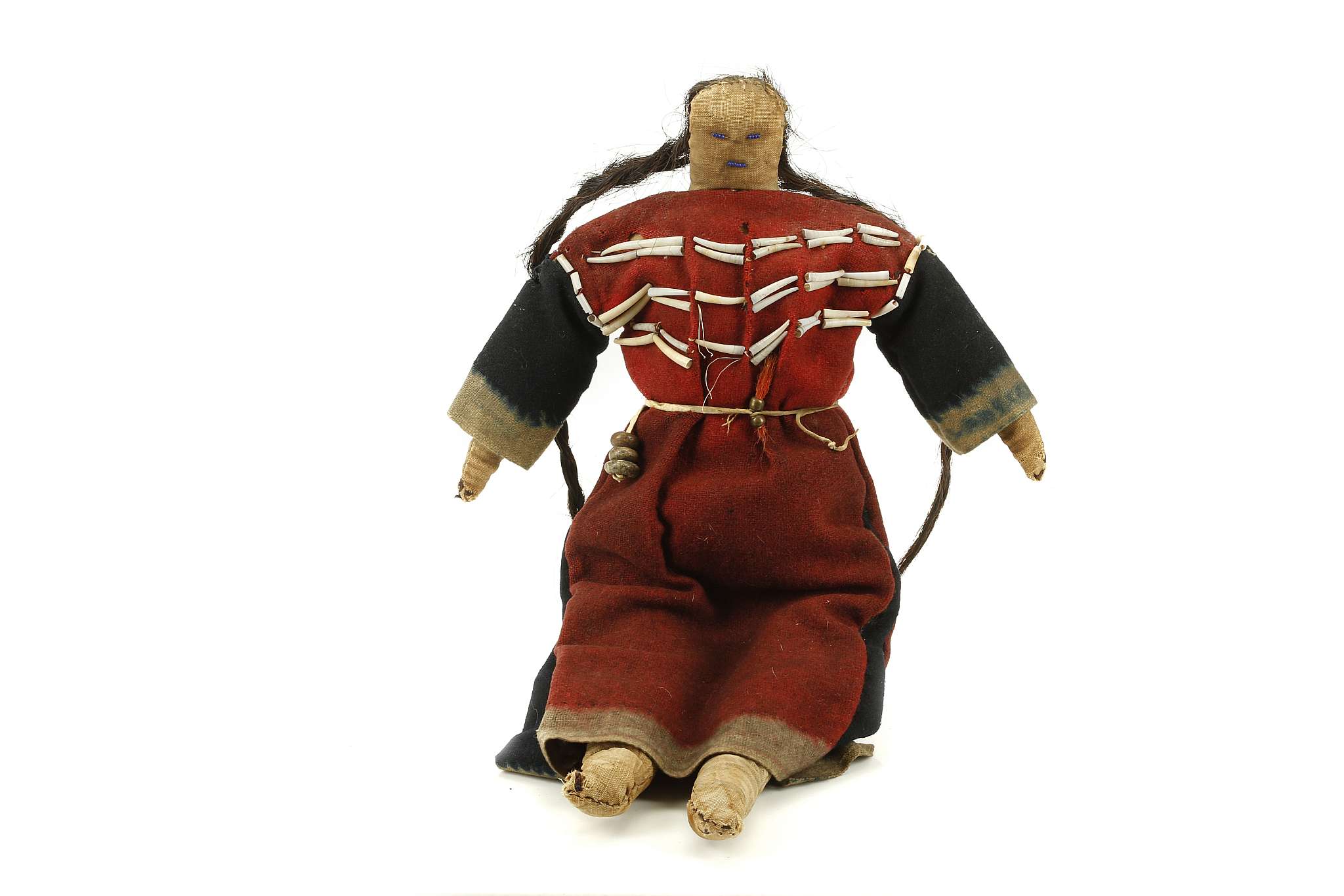 A NATIVE AMERICAN PLAINS BEADED CLOTH DOLL Wearing a traditional red and blue dress decorated with