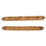 TWO ABORIGINAL WOODEN CLUBS Each carved with linear geometric designs, 26.5cm-28cm long, (2)