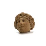 A HELLENISTIC-STYLE TERRACOTTA HEAD Finely moulded with handsome features, wearing a laurel wreath