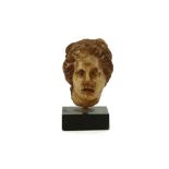 A ROMAN MARBLE HEAD OF APHRODITE Circa 1st-2nd Century A.D. The goddess depicted with centrally