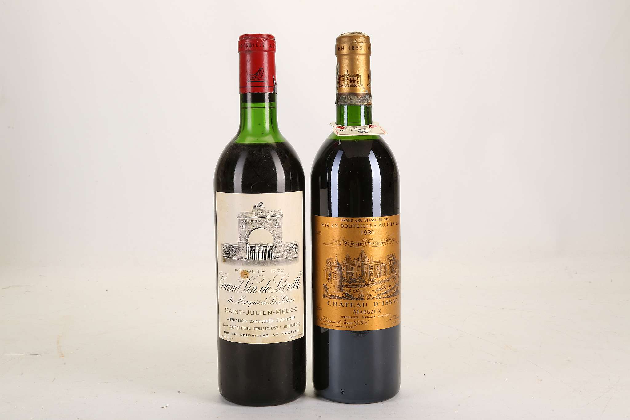 A 1985 Chateau D'Issan, Margaux, Grand Cru Classè cellar tag, 75cl (ABV unknown), and a bottle of