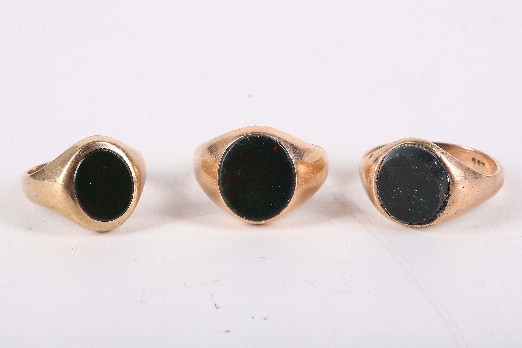 Three late 19th / early 20th century bloodstone signet rings. UK hallmarks for 9 and 15 carat yellow