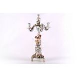 A late 19th Century Sitzendorf porcelain figural candelabra, the central column modelled in