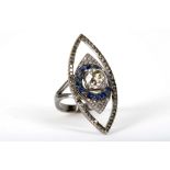 An 18ct gold, diamond and sapphire set dress ring, centred with a cushion cut diamond measuring 2.