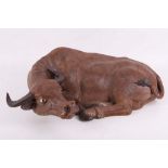 WITHDRAWN - A ceramic ox with seal marks at the back, seated with the head slightly raised and the