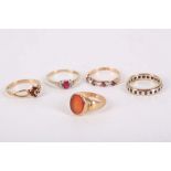 A collection of five rings, mounted in 9 carat yellow gold and set with garnets, diamonds and red