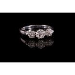 A triple cluster diamond ring, Set with three graduated flowerheads of brilliant-cut diamonds,