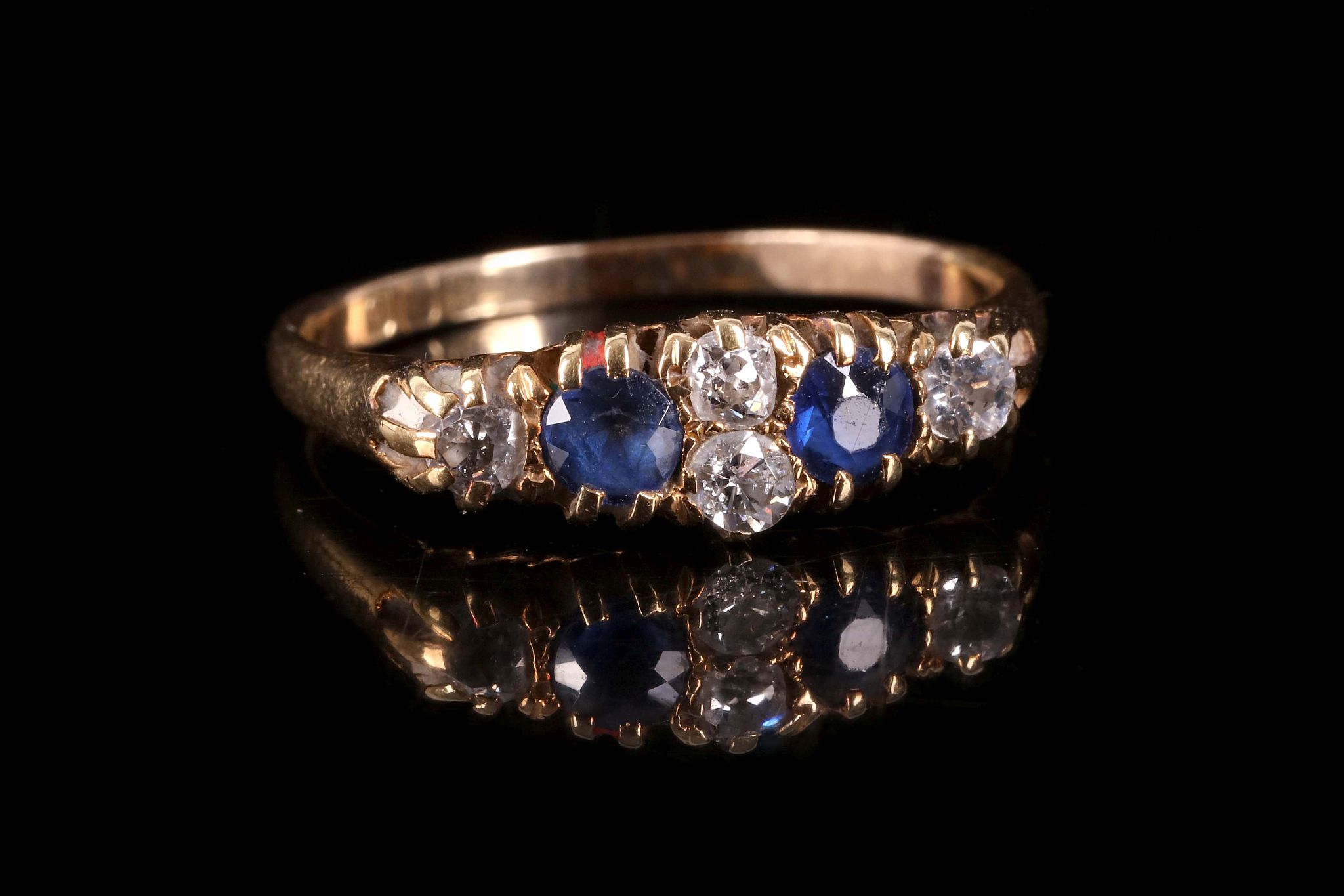 A sapphire and diamond ring, Set with circular-cut sapphires and old brilliant-cut diamonds, ring