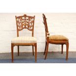 A pair of walnut Art Nouveau period dining chairs, with carved foliate backs and legs