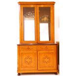 A continental bird's eye maple and rosewood marquetry bookcase cabinet, with a pair of glazed