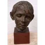 A painted terracotta sculpture of the head of a young boy, mounted on a hardwood cube base, 36cm