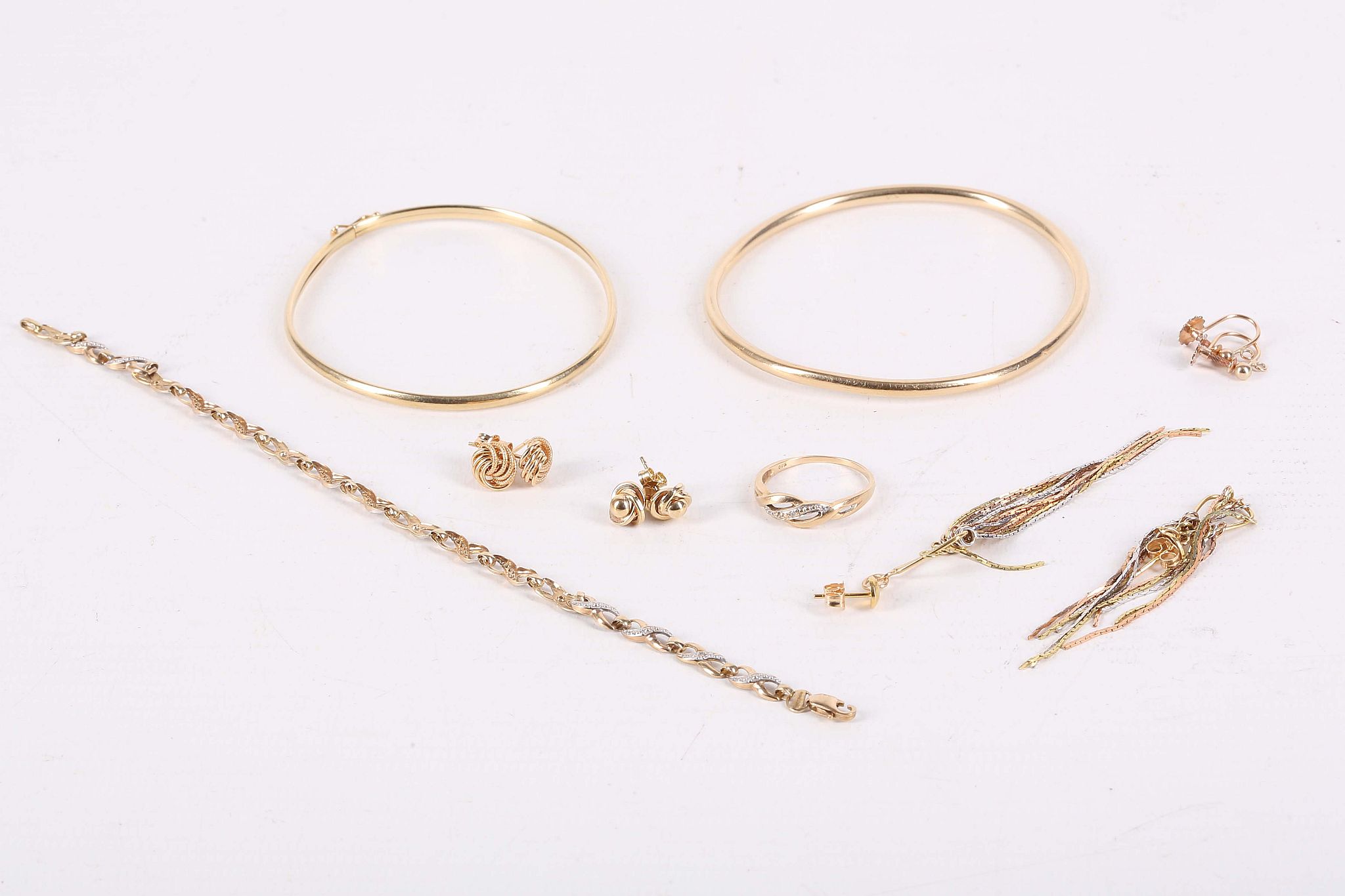 A collection of jewellery, Including two bangles, various earrings and a bracelet and ring suite,