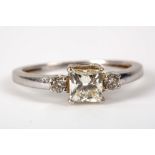 An 18ct white gold and diamond ring, the central square cut stone measuring 0.86ct estimate and