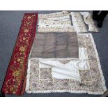 An Indian silk panel richly embroidered gold, silver and coloured silks, sold with gold coloured