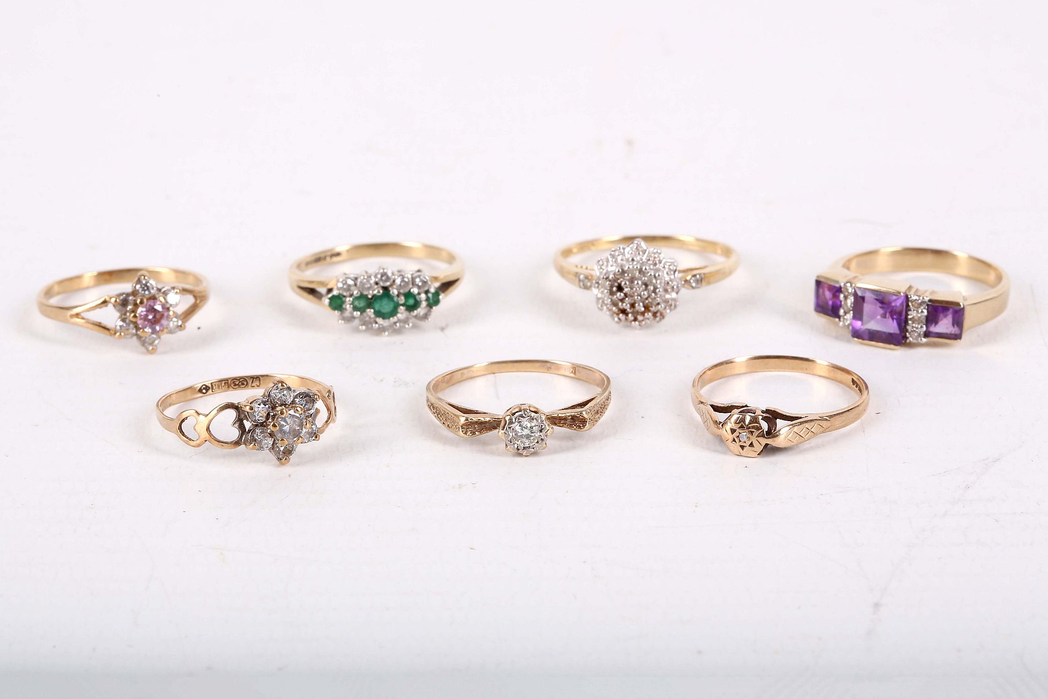 A collection of rings, set with CZ, diamonds, emeralds and amethyst, some with UK hallmarks for 9