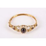 A gold, half pearl and garnet bangle, The 9 carat yellow gold bangle of foliate design, set with a