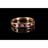 A ruby and diamond ring, Channel-set with square step-cut rubies and brilliant-cut diamonds, stamped