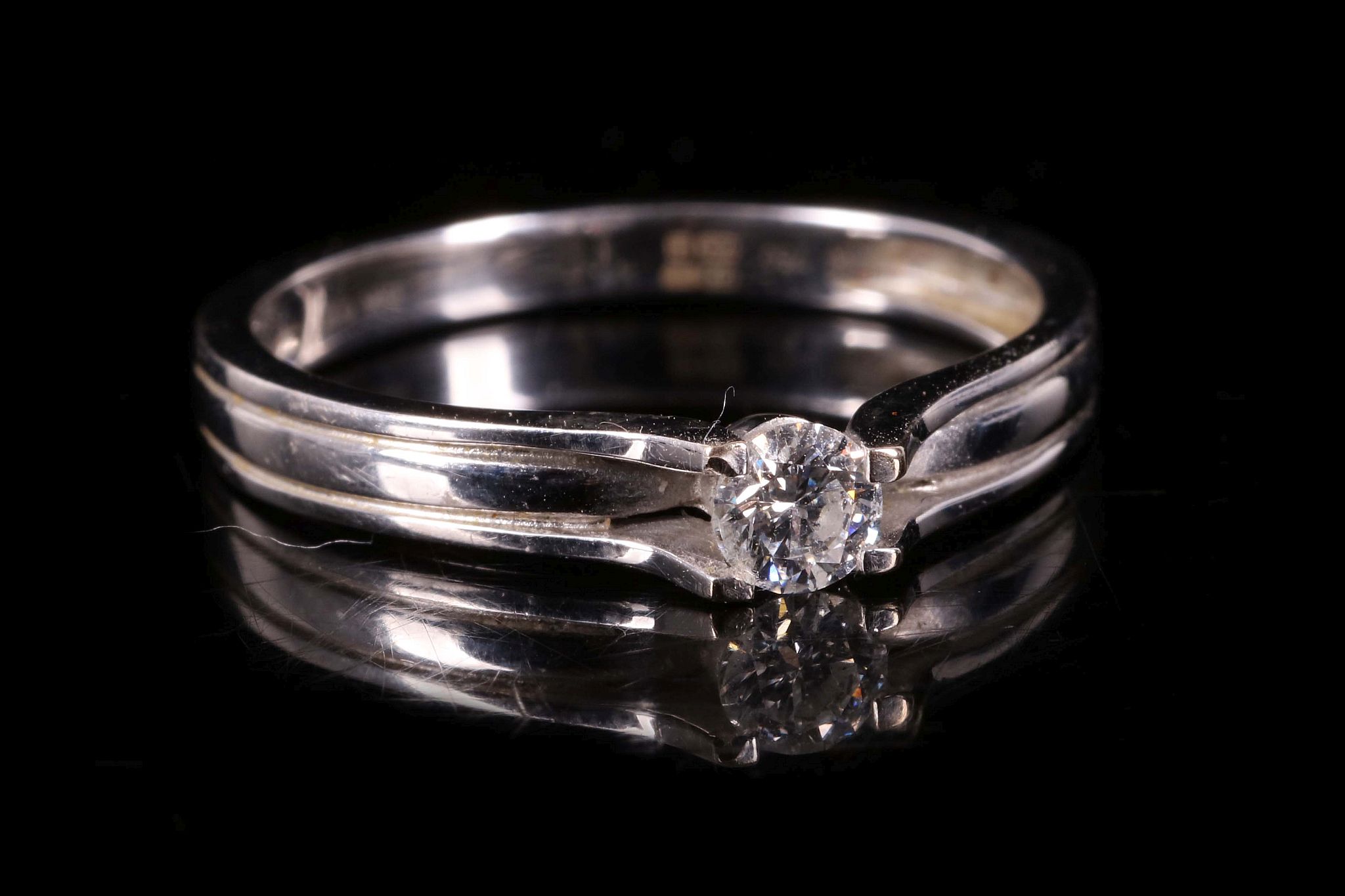 A diamond single-stone ring, Set with a brilliant-cut diamond, mounted in 18 carat white gold,