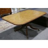 A Regency mahogany breakfast table, with cross banded top, on quadrapartite sabre legged base.