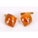 A pair of amber cufflinks, Each navette-shaped amber plaque to a baton terminal, unidentified