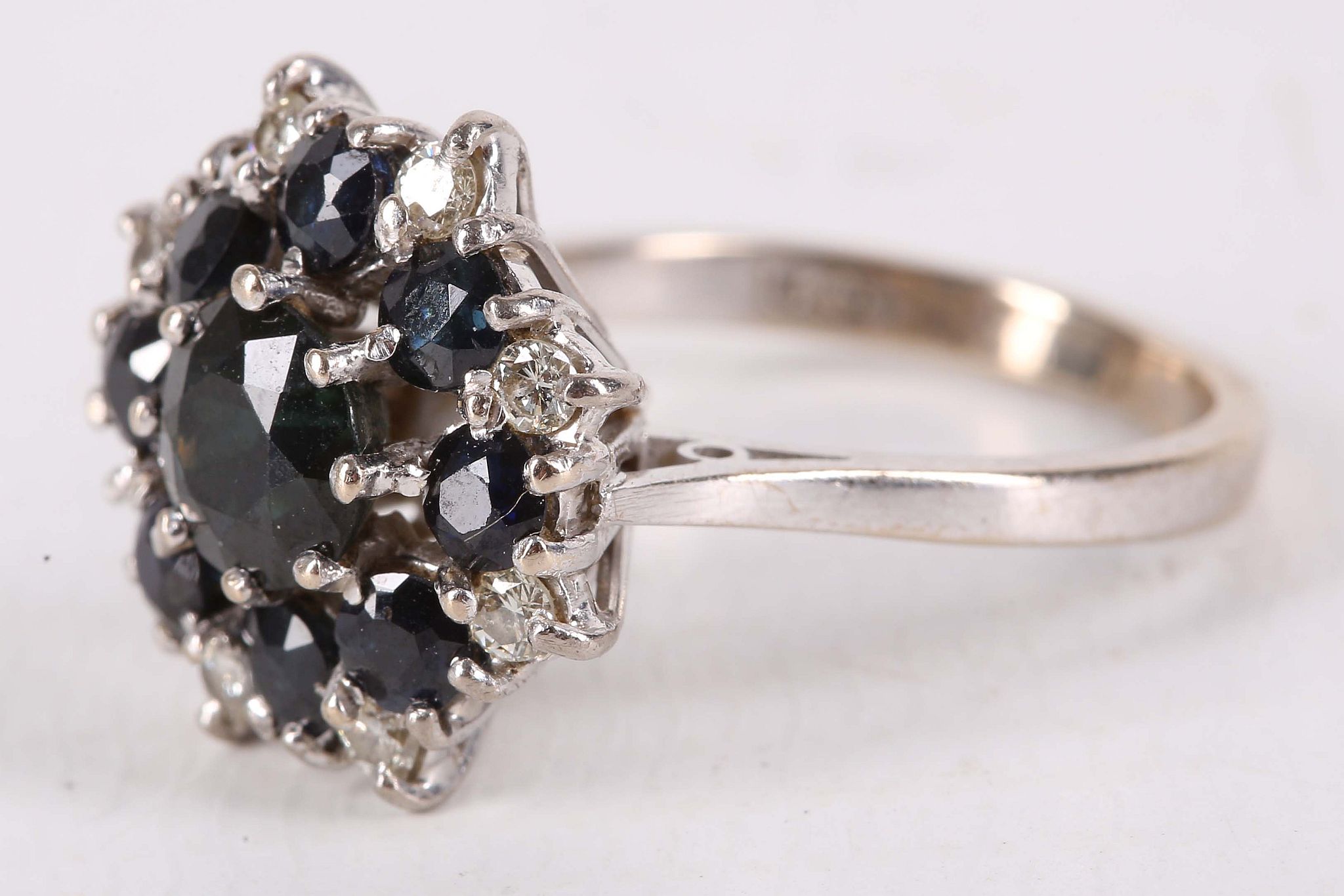 A sapphire and diamond cluster ring, Set with circular-cut sapphires and brilliant-cut diamonds, - Image 2 of 2