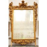 A giltwood pier mirror, en suite with the previous lot, the rectangular plate surrounded by highly
