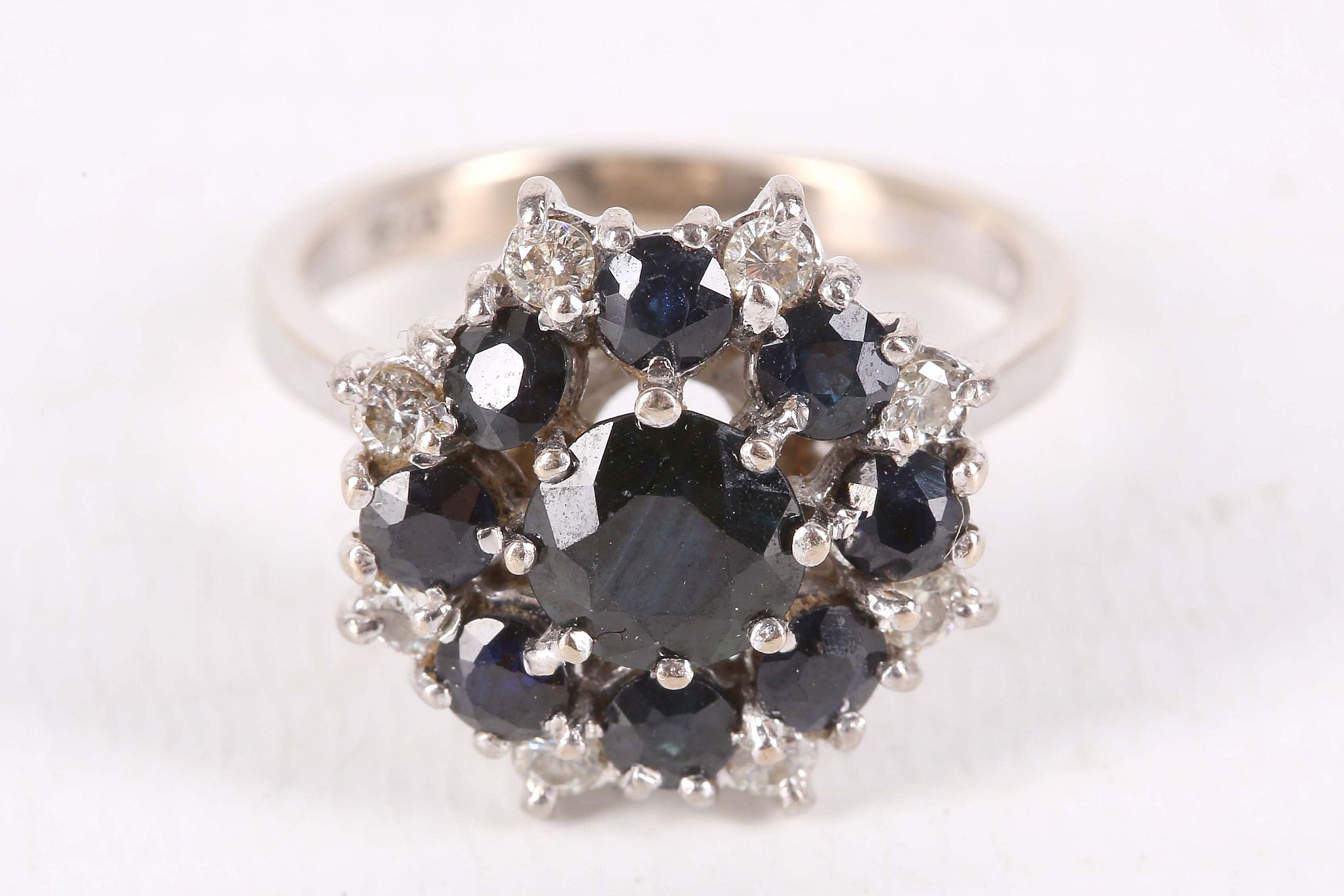 A sapphire and diamond cluster ring, Set with circular-cut sapphires and brilliant-cut diamonds,