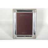 A modern Carrs of Sheffield, hallmarked silver photograph frame, having beaded border, mahogany back