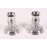 A pair of early 20th Century Dutch silver dwarf candlesticks embossed with windmill and sailing