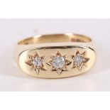 A diamond three-stone ring, The brilliant-cut diamonds gypsy-set in star motifs, mounted in 9