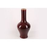 A Chinese oxblood vase with long and thin neck