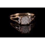 A diamond cluster ring, The raised central plaque pave-set with single-cut diamonds, stamped 375,