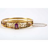 A 9ct gold Victorian ladies bangle set with central amethyst and seed pearl surround