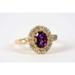 An 18ct yellow gold, amethyst and diamond cluster ring.