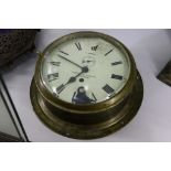 An early 20th Century heavy brass mounted ship clock by Christie & Wilson of Glasgow, having Roman