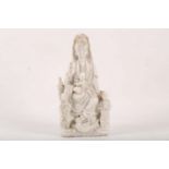 A 19th Century Chinese blanc de chine figure of Guanyin, with two attendants, 22cm