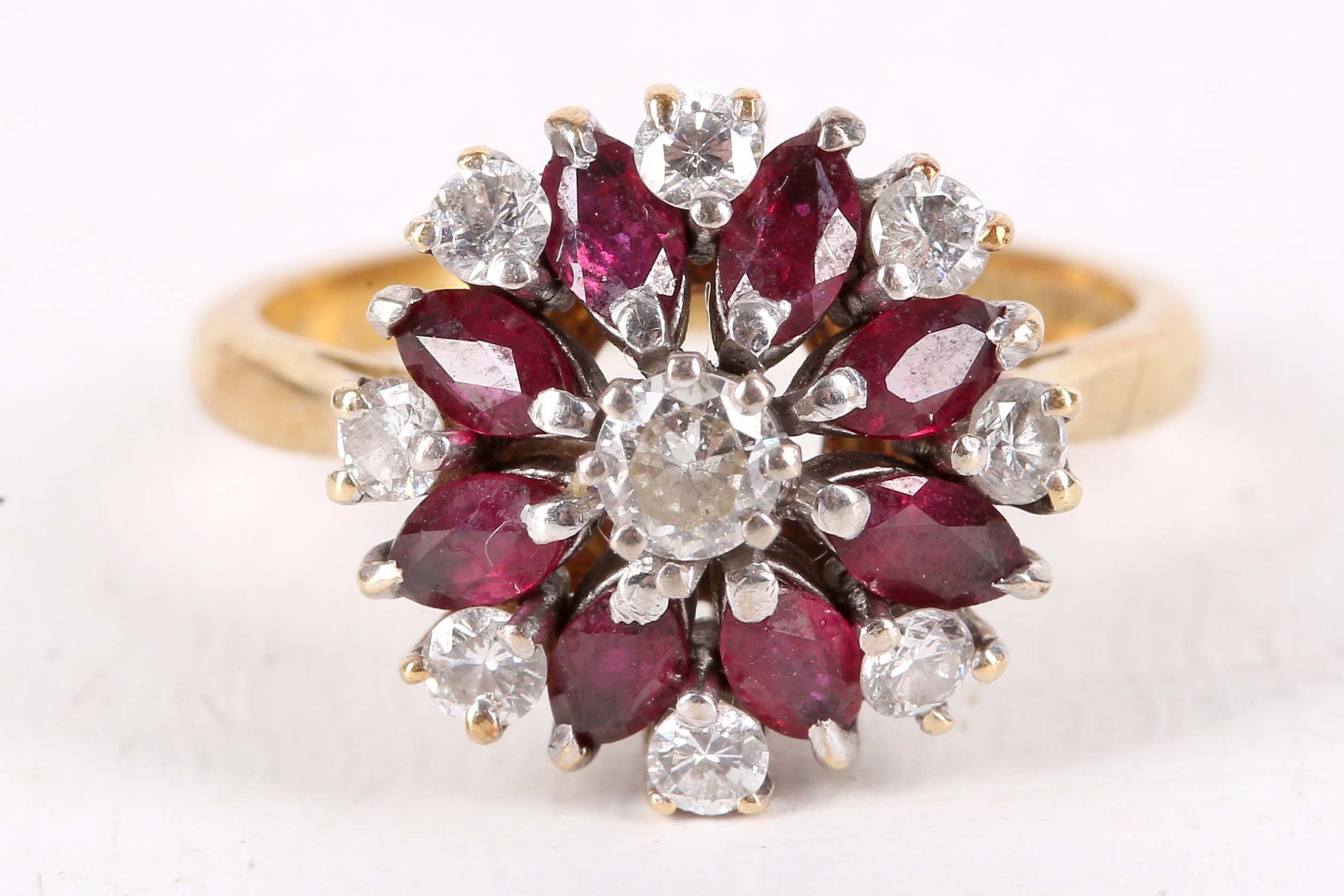 A garnet and diamond cluster ring, Set with circular-cut garnets and brilliant-cut diamonds, mounted