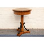A 19th Century circular top Biedermeier occasional table; having a three footed base with three
