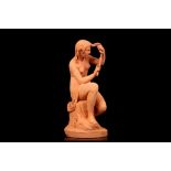 A FINE EARLY 19TH CENTURY FRENCH TERRACOTTA FIGURE OF HERMINIE CUTTING HER HAIR the seated figure