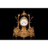 A LATE 19TH CENTURY FRENCH GILT BRONZE MANTEL CLOCK the case modelled as a pedestal with fluted base
